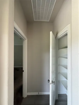 a spacious bathroom with a double vanity sink and a mirror