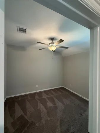en empty room with a fan