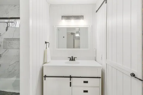 a bathroom with a sink and a mirror
