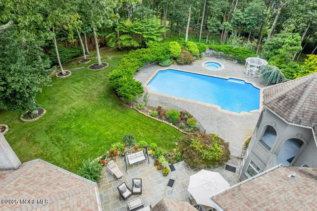 an aerial view of a house with a yard and lake view