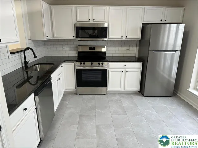 a kitchen with a stove and a refrigerator
