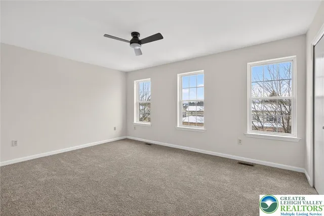 a bedroom with a bed couch and window
