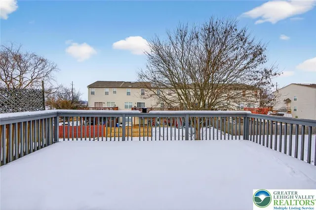 a view of a house with a wooden deck