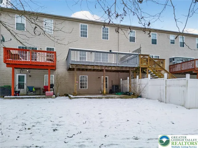 a roof deck with table and chairs