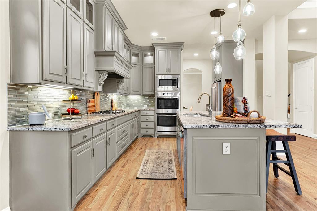 2804 Seabiscuit Road Celina, TX 75009 - Photo 11 of 40 a kitchen with stainless steel appliances granite countertop a sink and cabinets