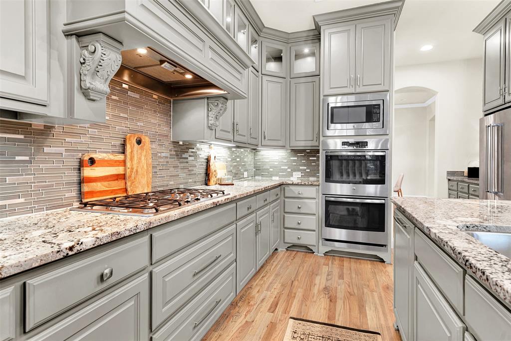2804 Seabiscuit Road Celina, TX 75009 - Photo 13 of 40 a kitchen with stainless steel appliances granite countertop a stove and a sink