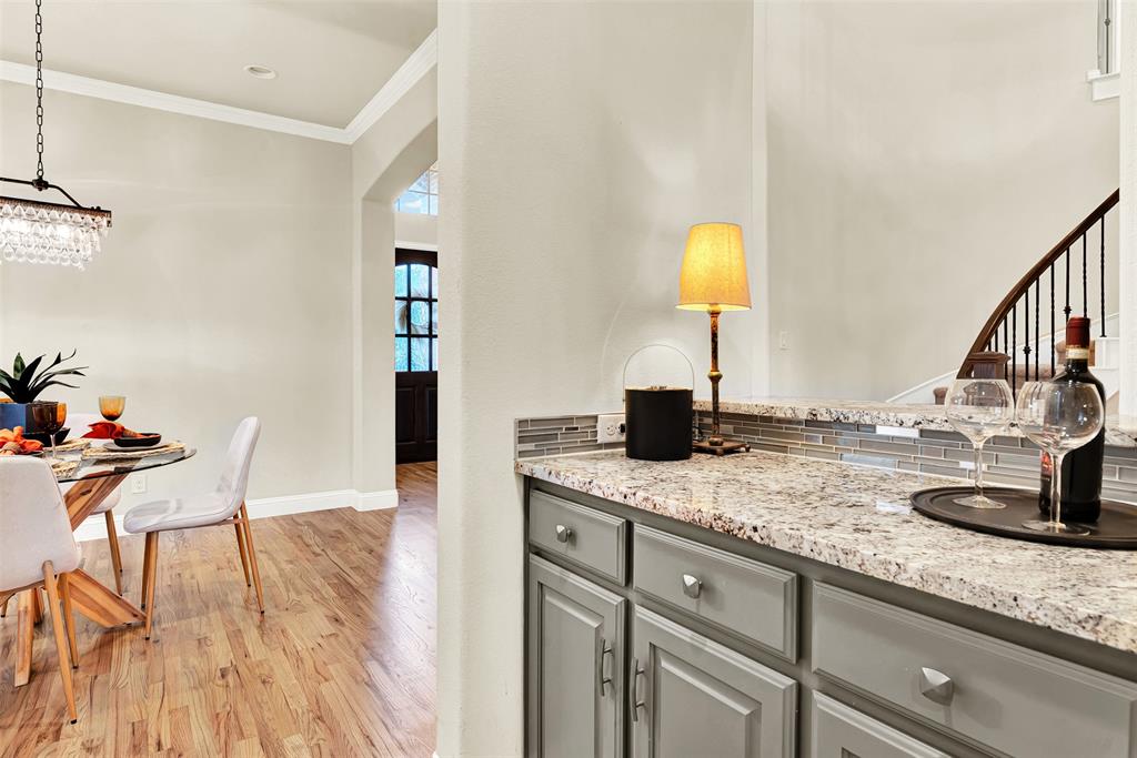 2804 Seabiscuit Road Celina, TX 75009 - Photo 14 of 40 a kitchen with granite countertop a sink cabinets and wooden floor