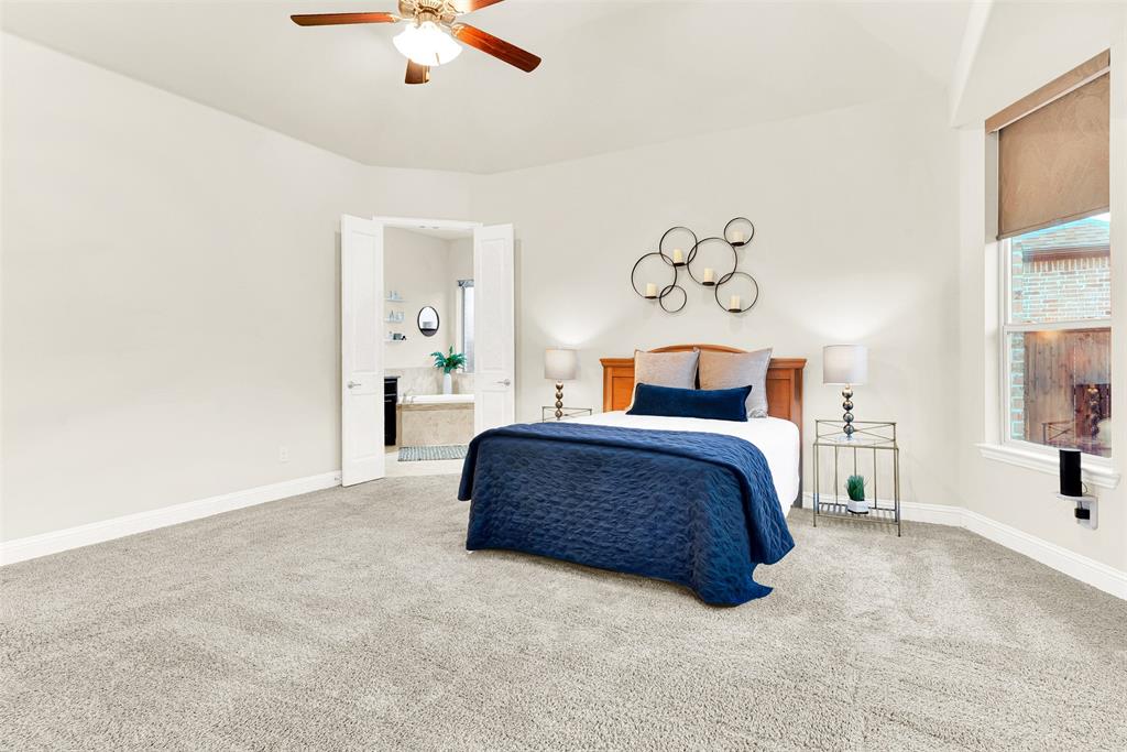 2804 Seabiscuit Road Celina, TX 75009 - Photo 17 of 40 a bedroom with a bed and a chandelier