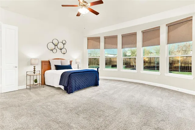 a spacious bedroom with a large bed and a large window