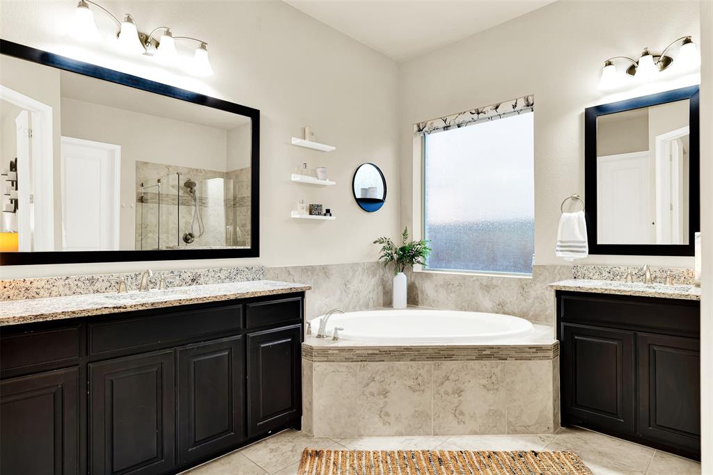 2804 Seabiscuit Road Celina, TX 75009 - Photo 19 of 40 a bathroom with a granite countertop sink mirror and a bathtub