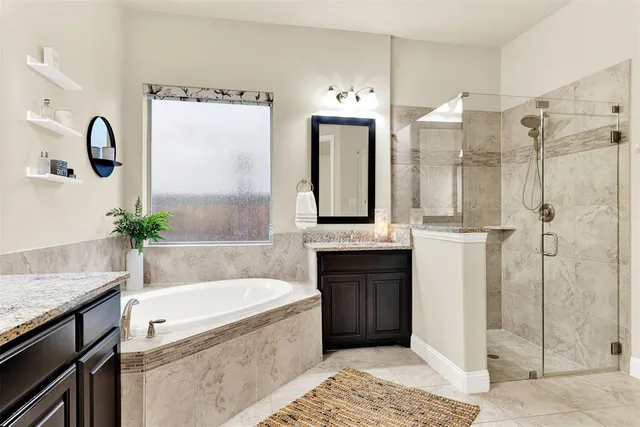 a bathroom with a tub sink and mirror