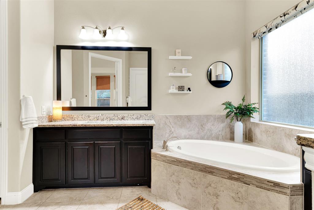 2804 Seabiscuit Road Celina, TX 75009 - Photo 21 of 40 a bathroom with a tub sink and mirror