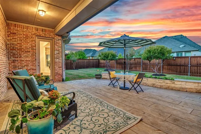 a view of a patio with a table and chairs
