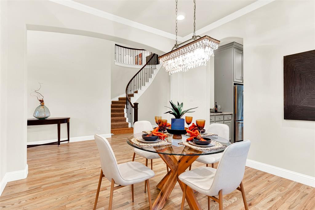 2804 Seabiscuit Road Celina, TX 75009 - Photo 3 of 40 a dining room with furniture and wooden floor