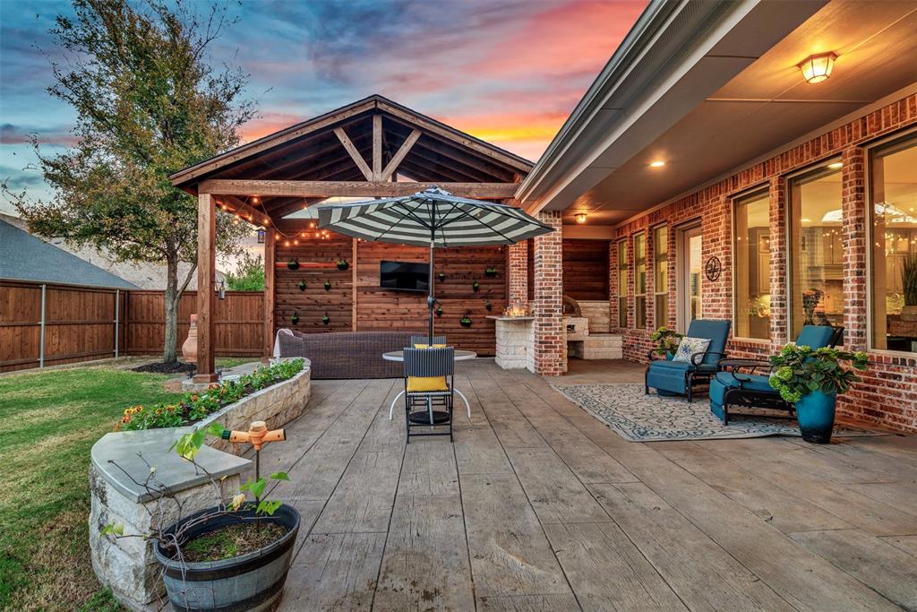 2804 Seabiscuit Road Celina, TX 75009 - Photo 31 of 40 a view of a patio with table and chairs potted plants with wooden floor and fence