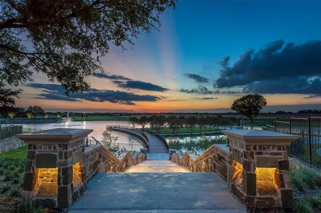 an aerial view of a house with outdoor space pool patio and lake view