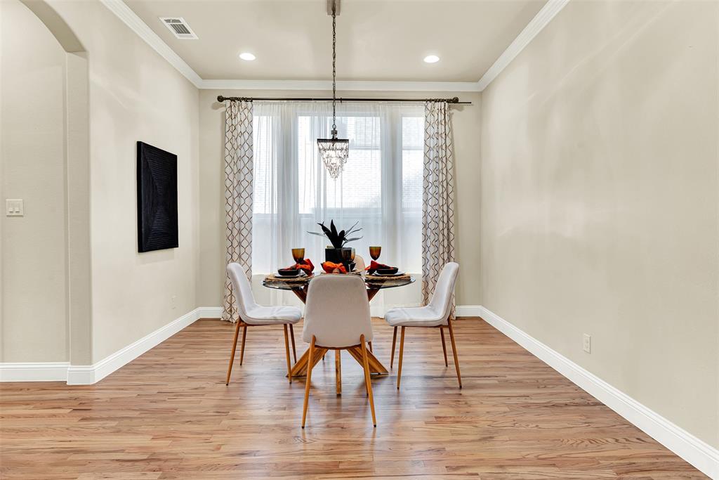 2804 Seabiscuit Road Celina, TX 75009 - Photo 4 of 40 a view of a a dining room with furniture window and wooden floor