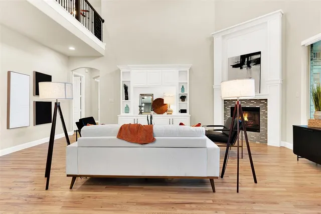 a living room with furniture a fireplace and a flat screen tv