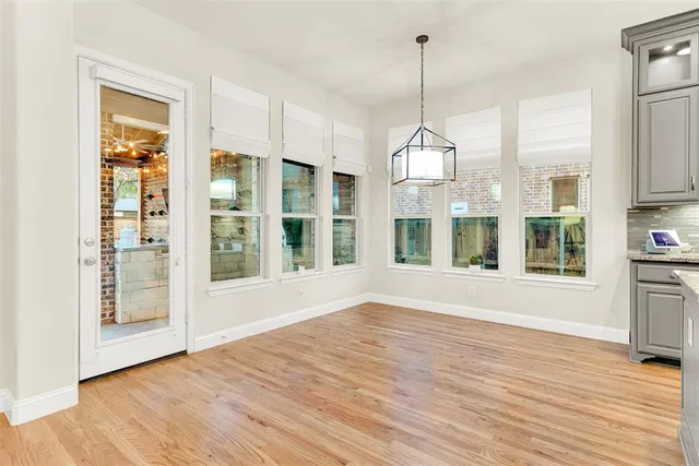 a view of a room with wooden floor and windows