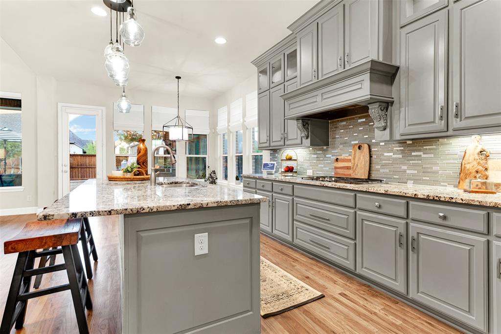 2804 Seabiscuit Road Celina, TX 75009 - Photo 10 of 40 a kitchen with stainless steel appliances granite countertop a sink a stove and cabinets