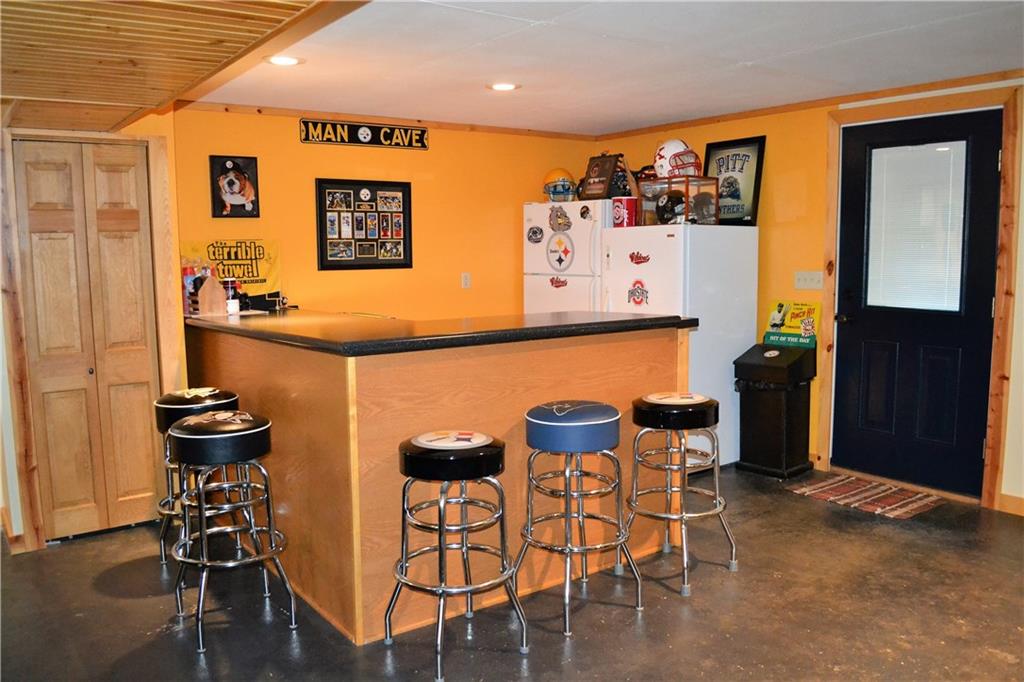 119 Pine Tree Road Kittanning, PA 16201 - Photo 19 of 25 The bar is included and is a great place to hangout and entertain. The walkout basement leads to the private back yard.