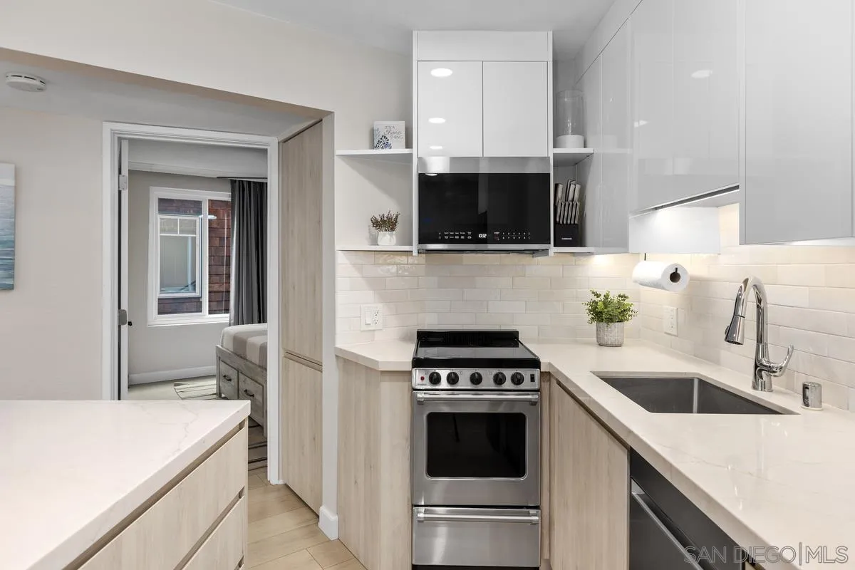8040 Girard Avenue, Unit 2 La Jolla, CA 92037 - Photo 14 of 27 a kitchen with a sink and a stove top oven