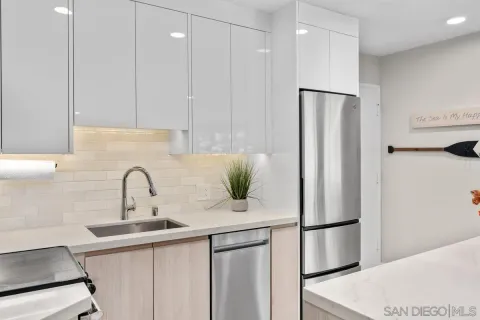 a kitchen with a refrigerator and a sink