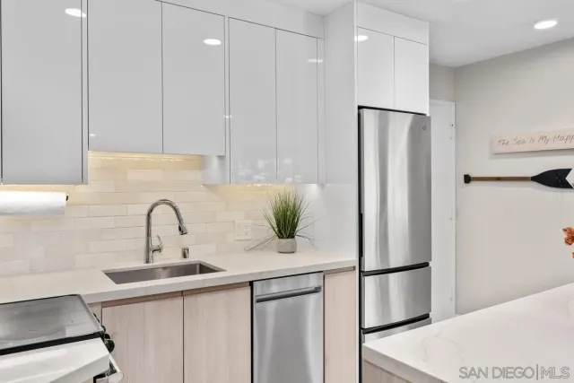 a kitchen with a refrigerator and a sink