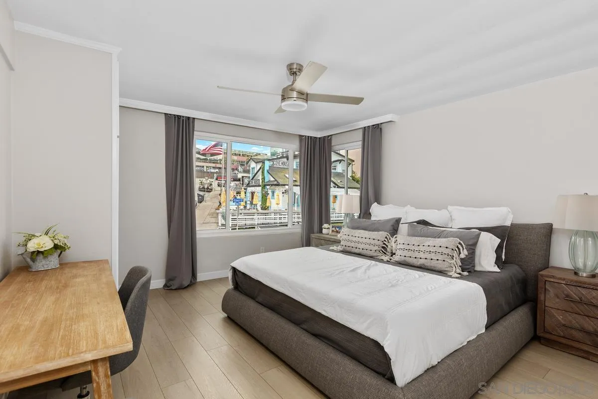 8040 Girard Avenue, Unit 2 La Jolla, CA 92037 - Photo 19 of 27 a bedroom with a bed and wooden floor