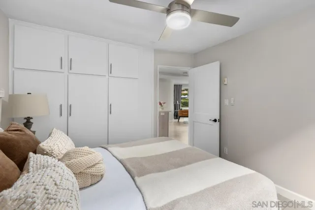 a bedroom with a large bed and a chandelier