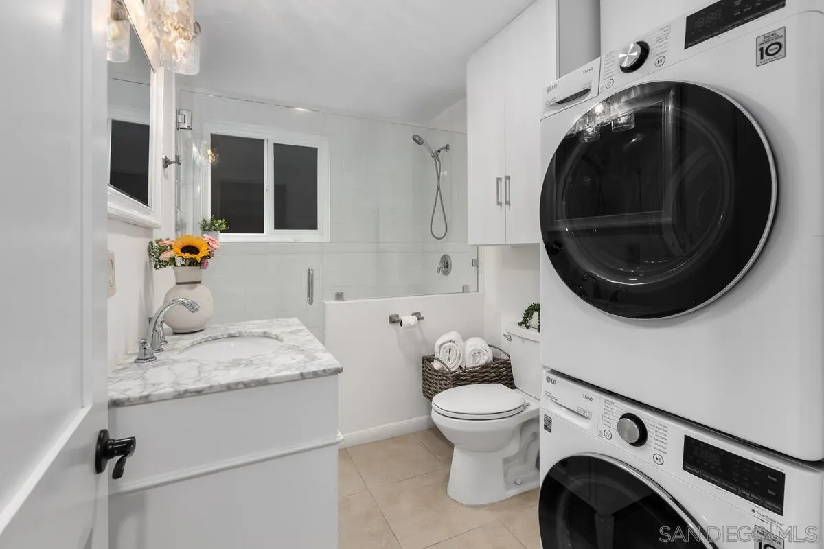 8040 Girard Avenue, Unit 2 La Jolla, CA 92037 - Photo 25 of 27 a bathroom with a sink and a washer dryer