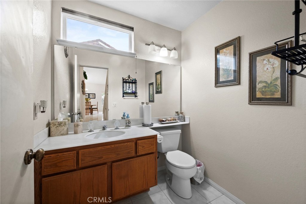 605 Bronco Way Walnut, CA 91789 - Photo 28 of 69 a bathroom with a toilet sink vanity and mirror
