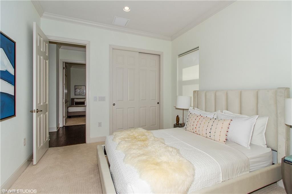 9293 Quarry Drive Naples, FL 34120 - Photo 11 of 28 a bedroom with a bed and closet