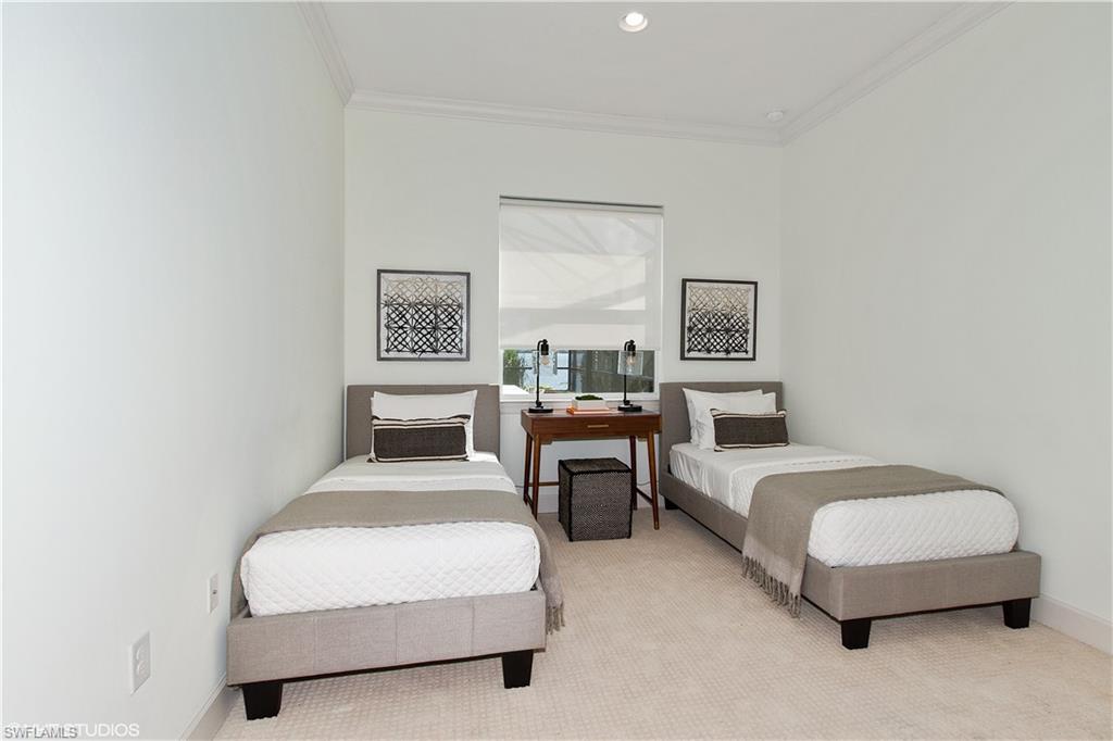 9293 Quarry Drive Naples, FL 34120 - Photo 13 of 28 a bedroom with a bed lamp and couch