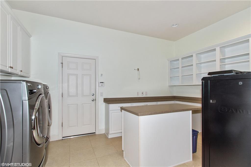 9293 Quarry Drive Naples, FL 34120 - Photo 16 of 28 a utility room with dryer and washer
