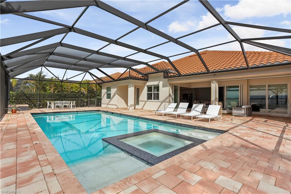 9293 Quarry Drive Naples, FL 34120 - Photo 20 of 28 a view of a patio with a swimming pool