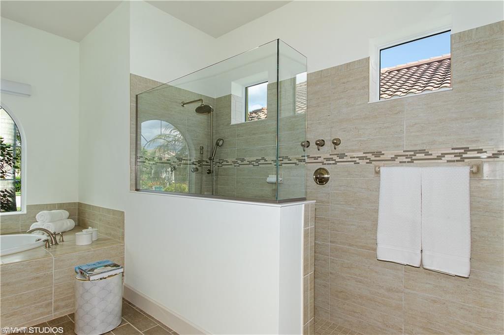 9293 Quarry Drive Naples, FL 34120 - Photo 9 of 28 a bathroom with a granite countertop shower toilet and sink