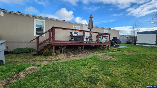a view of a house with a backyard and a patio
