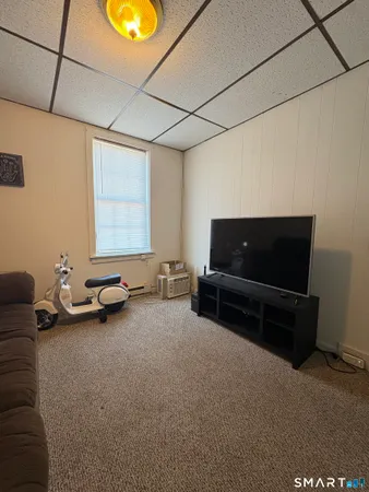 a room with furniture and flat screen tv