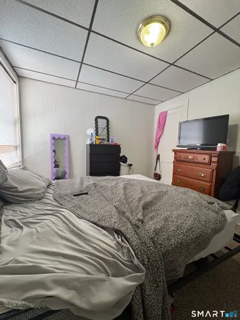 a bedroom with a bed and dresser