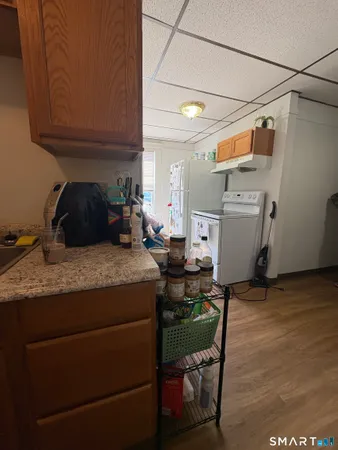a kitchen with a sink cabinets and wooden floor