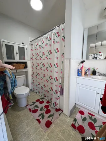a bathroom with a sink toilet and shower