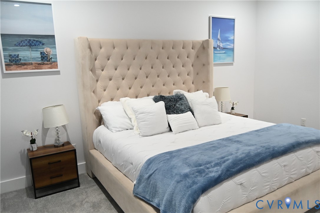 2721 Terminal Avenue Richmond, VA 23234 - Photo 21 of 30 a large bed sitting in a bedroom next to a lamp
