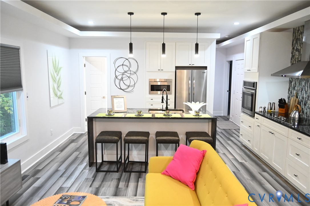 2721 Terminal Avenue Richmond, VA 23234 - Photo 6 of 30 a living room with granite countertop furniture a fireplace and kitchen view