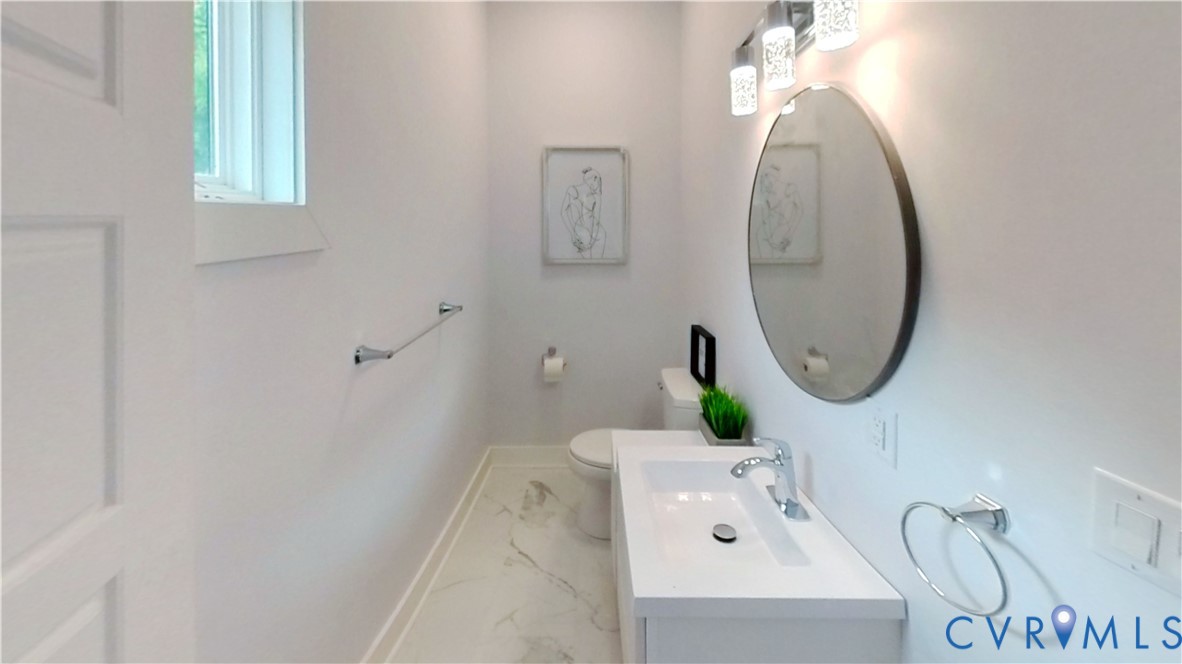 2721 Terminal Avenue Richmond, VA 23234 - Photo 7 of 30 a bathroom with a sink mirror and vanity