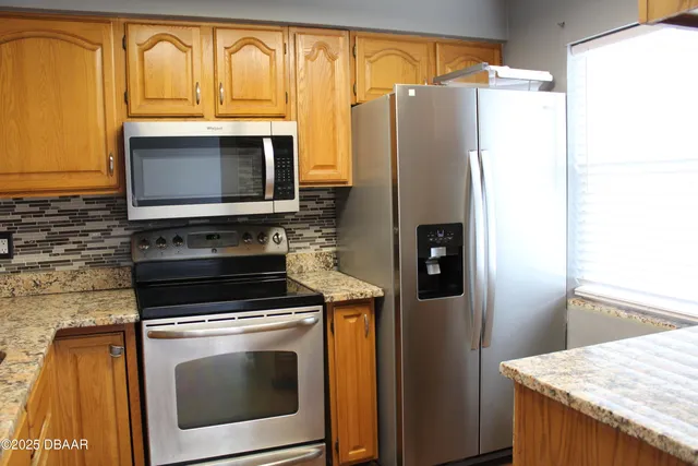 a kitchen with a refrigerator stove and microwave