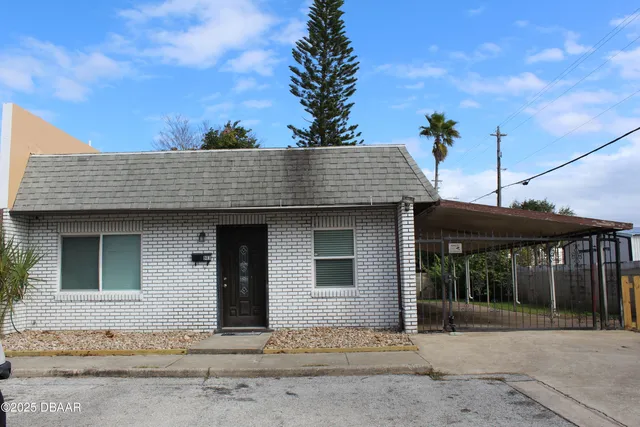 a front view of a house with a garden