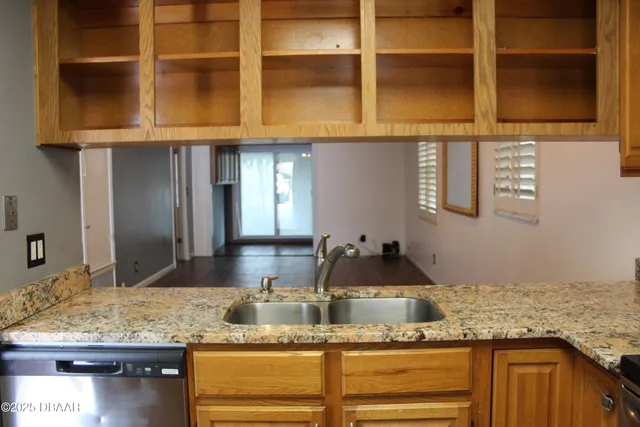 a kitchen with granite countertop a sink and a window
