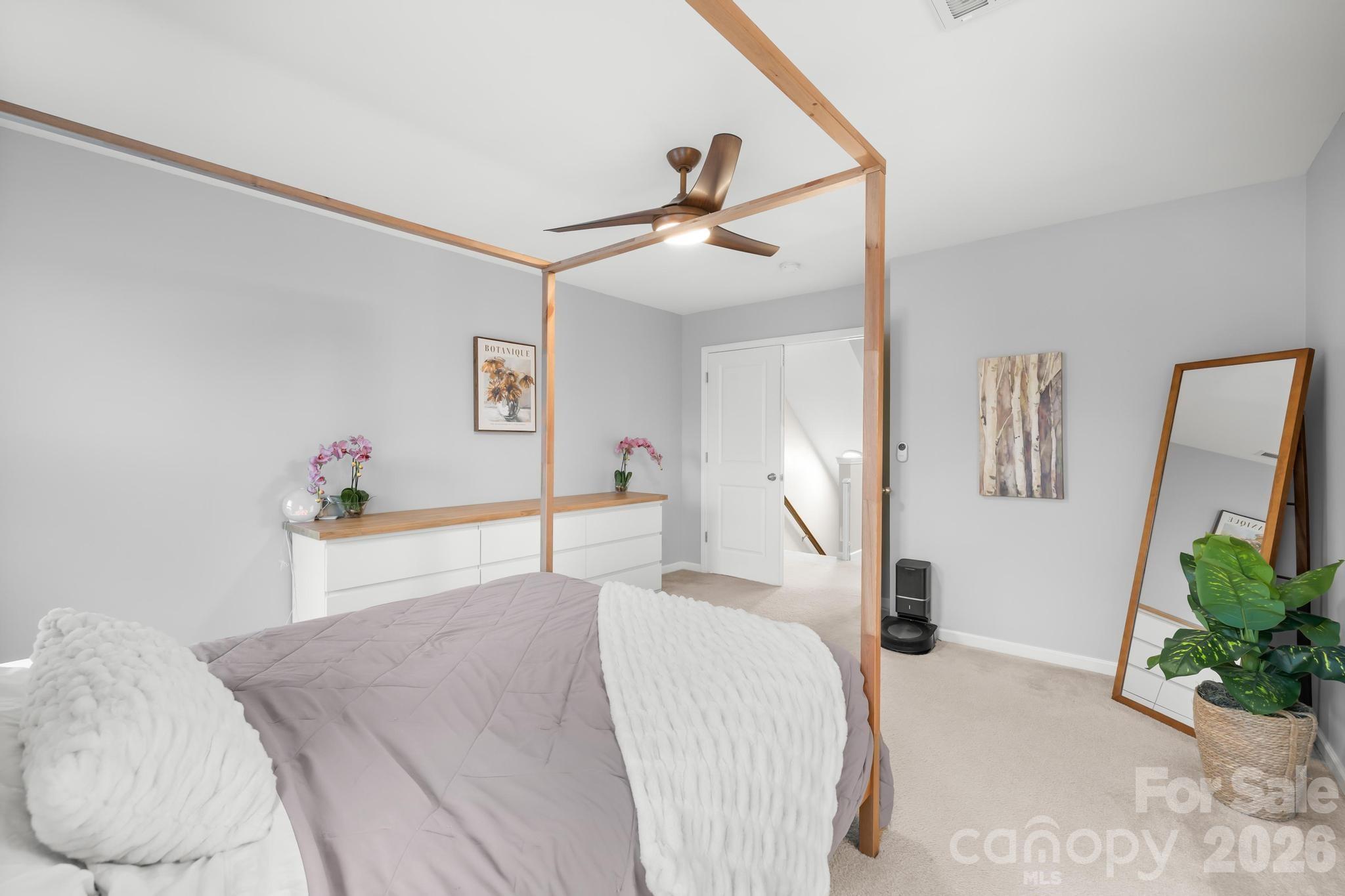5020 Fenwick Court Lancaster, SC 29720 - Photo 16 of 46 a bed room with a bed mirror and a potted plant