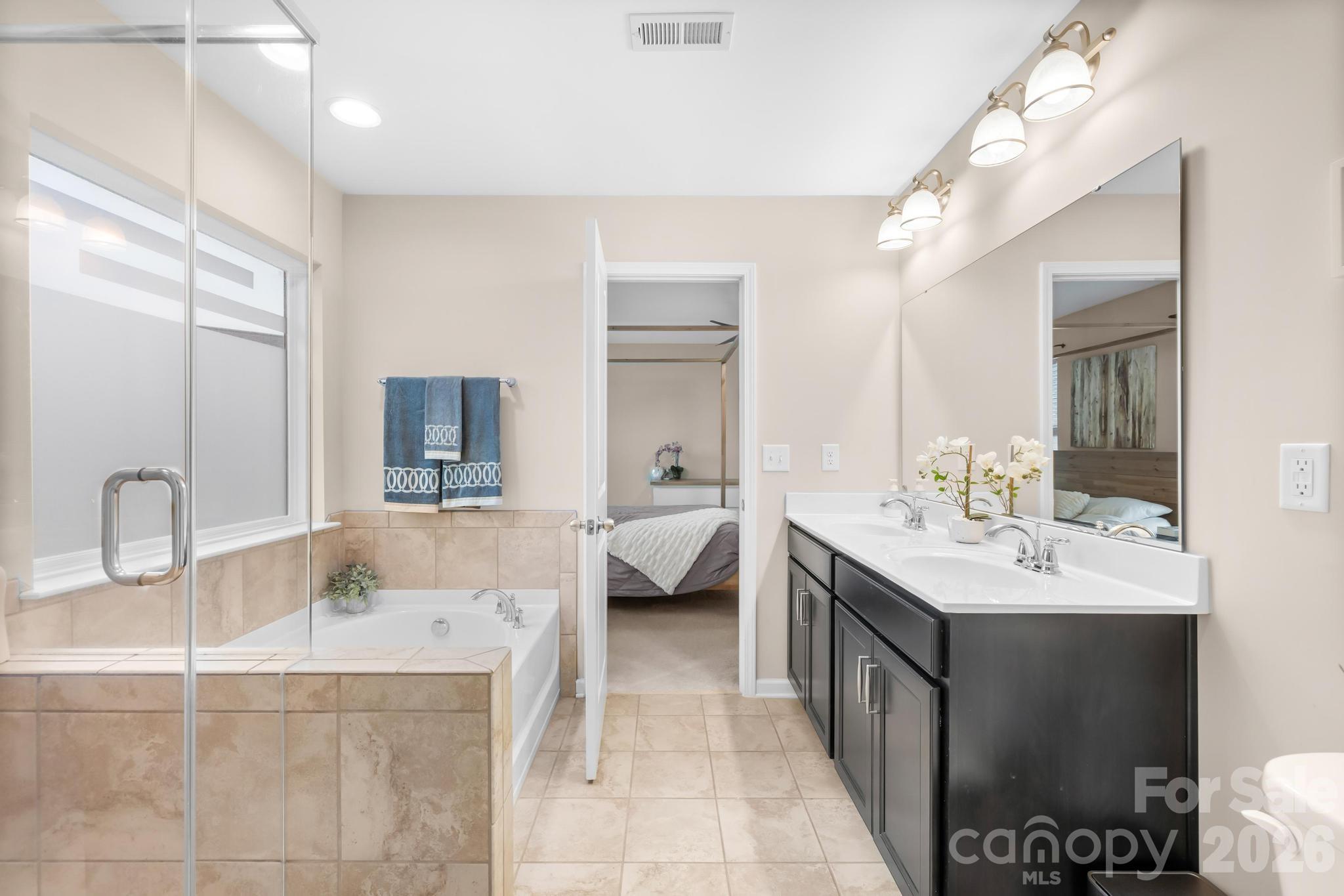 5020 Fenwick Court Lancaster, SC 29720 - Photo 17 of 46 a en suite bathroom with a granite countertop sink and a mirror